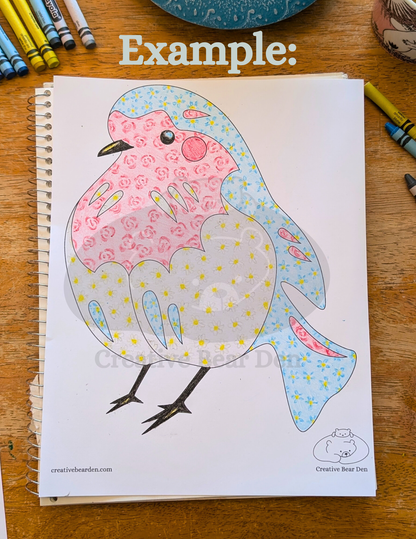 Coloring book with a bird design on a wooden surface with crayons around